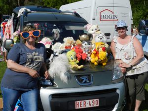 Een standje op de motorkap met beren en poppen en een grote zonnebril